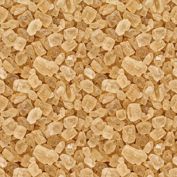 Seamless tileable texture of raw cane sugar in extreme close-up showing micro-detail