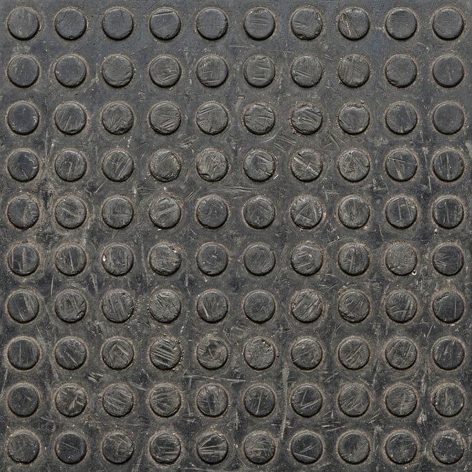 Seamless tileable texture of rubber mat heavily worn and patinated