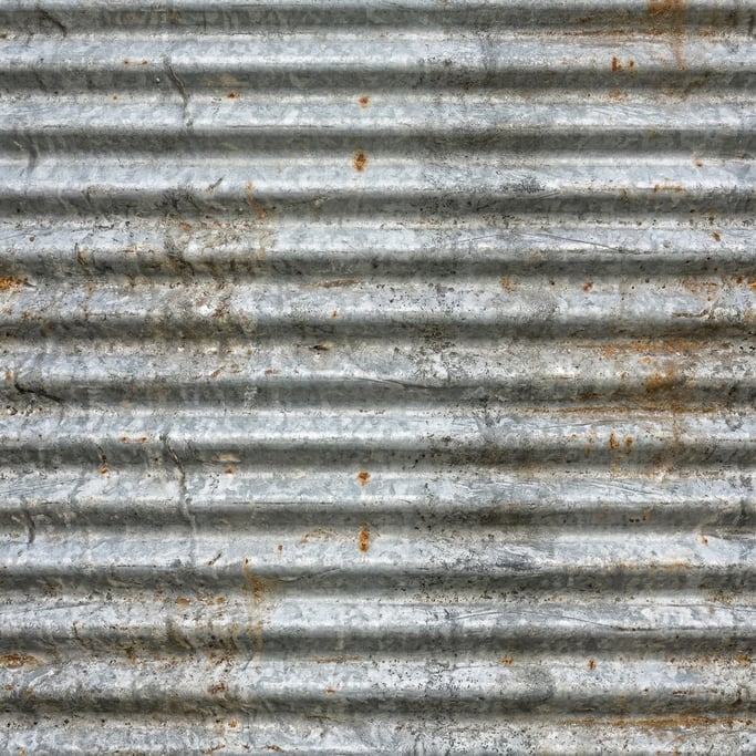 Seamless tileable texture of corrugated metal lightly weathered and aged
