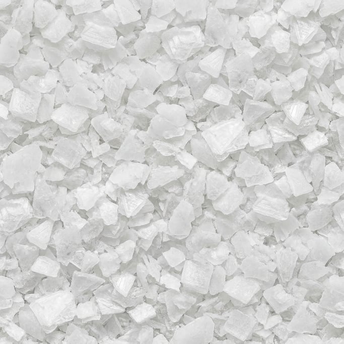 Seamless tileable texture of coarse sea salt in extreme close-up showing micro-detail