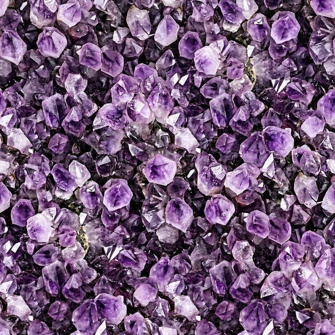 Seamless tileable texture of amethyst crystal surface freshly cut and raw