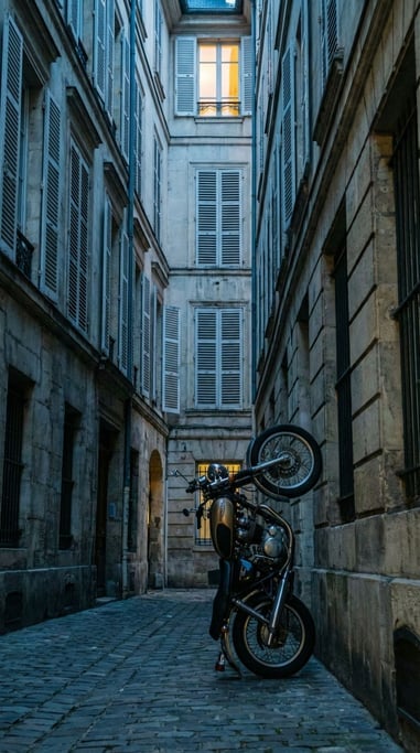Motorcycle parked vertically in frame on a narrow European street