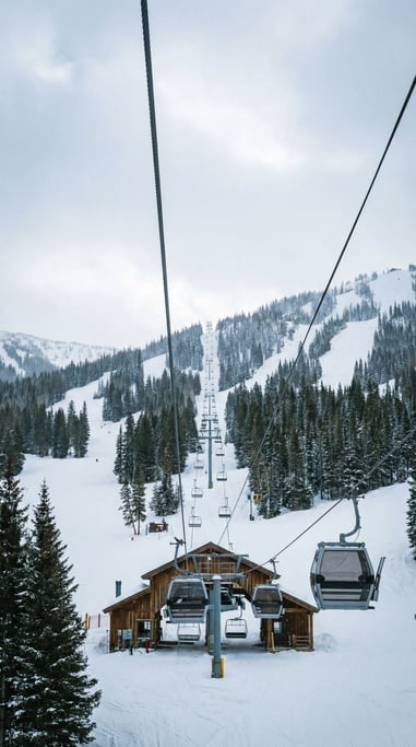Vertical shot of a gondola lift ascending a ski mountain