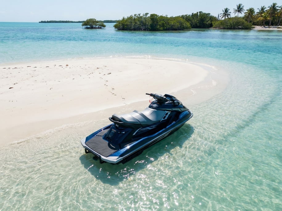 Jet ski beached on a sandbar, turquoise shallow water around it, no rider