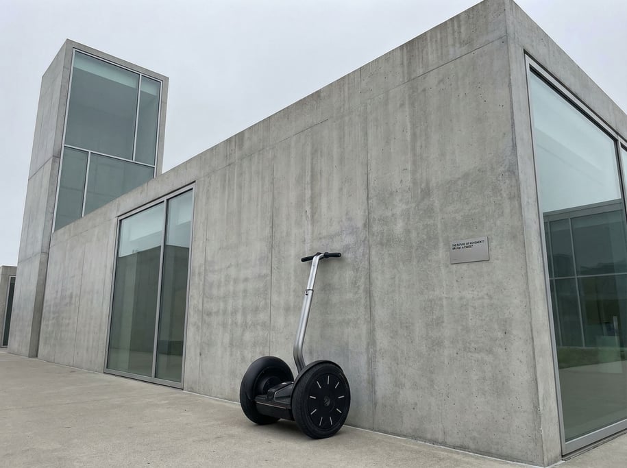 Segway-style personal transporter leaning against a modern museum wall