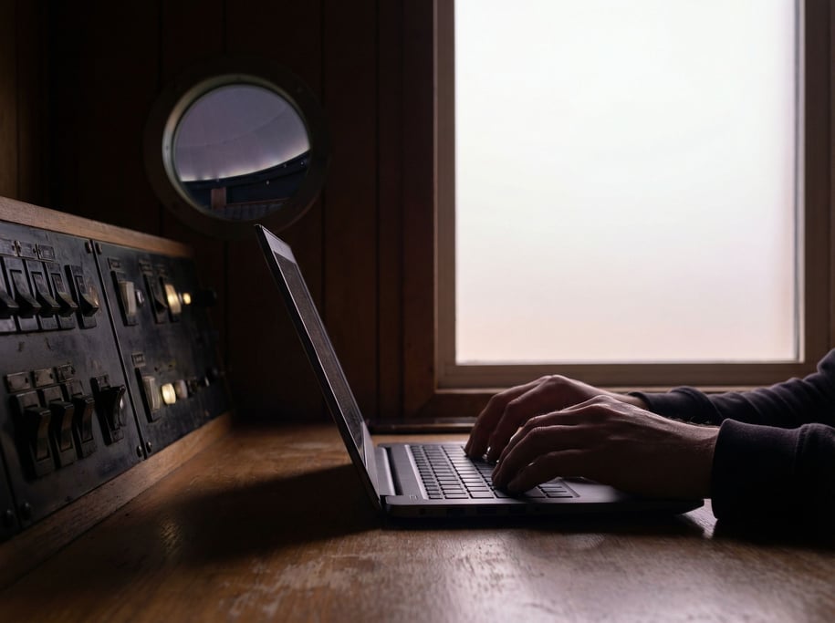 A planetarium control room, laptop next to a bank of dimmed switches (t0udwgw7)