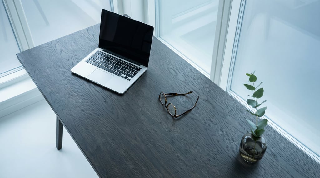 Overhead bird's-eye view looking directly down at a clean deep charcoal-stained oak desk surface
