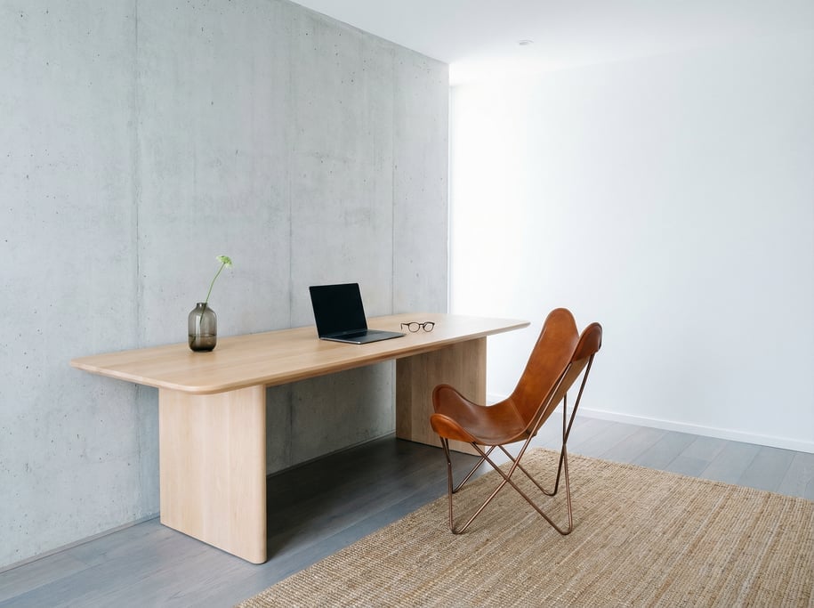 Pulled-back wide shot showing the full room with of a photographer's editing desk