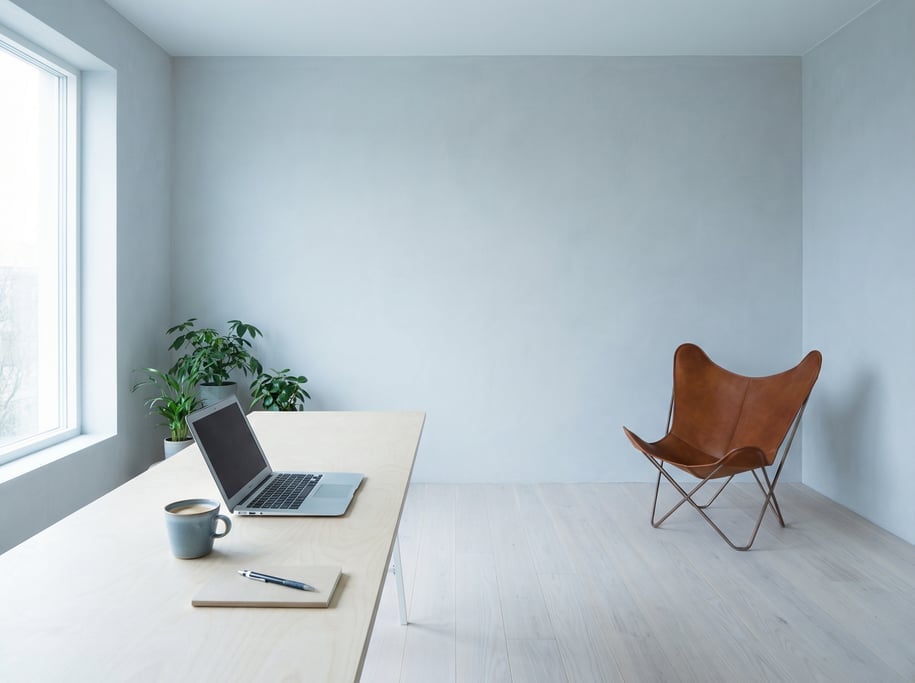 Pulled-back wide shot showing the full room with of a zen-inspired workspace