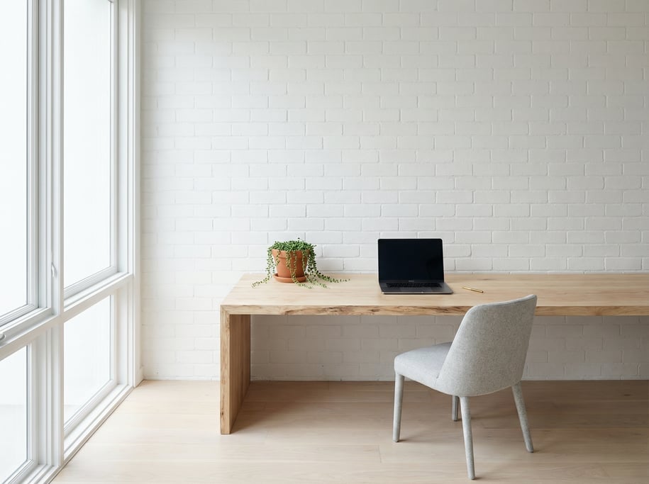 Wide straight-on photograph of a coastal-inspired bright workspace
