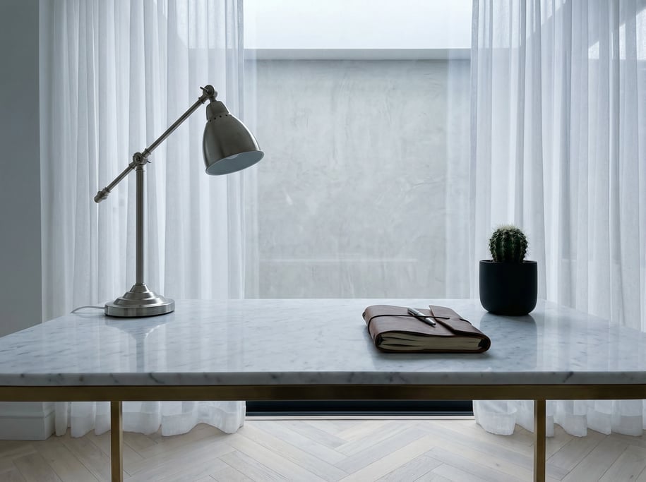 First-person perspective standing at the front edge of the desk