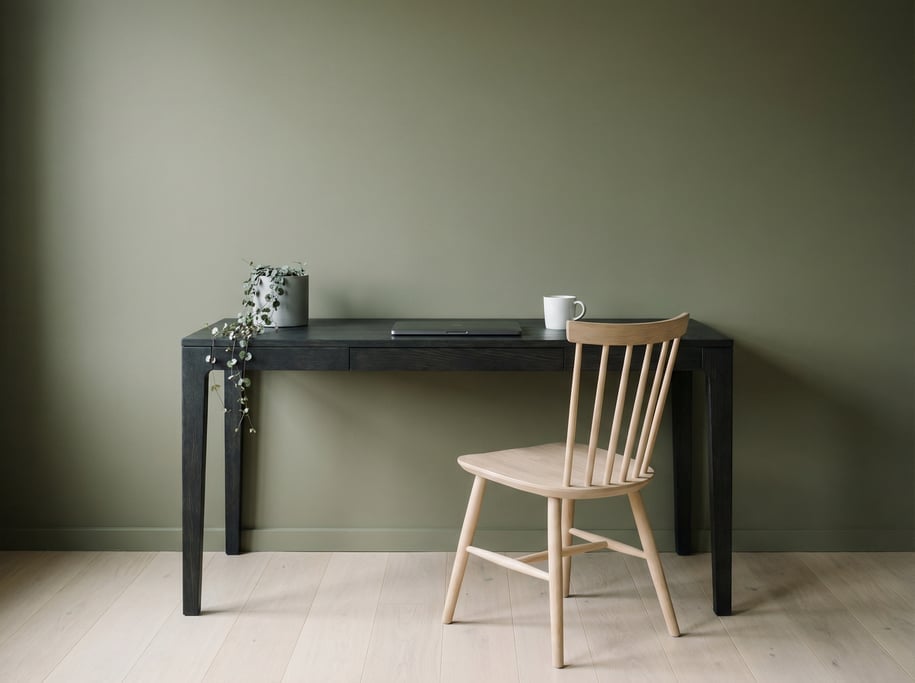 Straight-on architectural photograph of a clean freelancer workspace